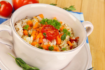 Delicious rice with vegetables and herbs in pot