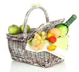 Picnic basket with fruits and bottle of wine, isolated on white