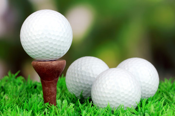 Golf balls on grass outdoor close up