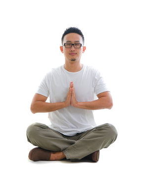 chinese male performing yoga with white background