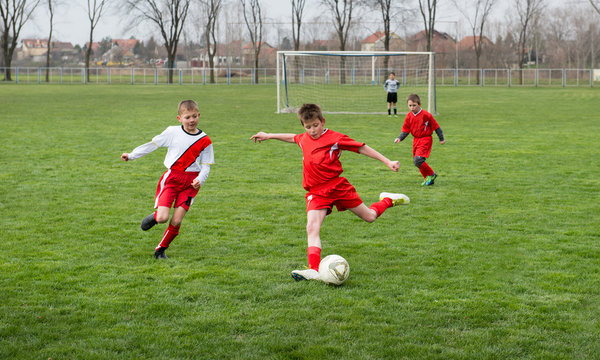 boys  kicking football