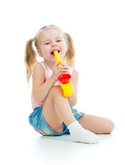 Funny baby  girl playing with musical toy. Isolated on white bac