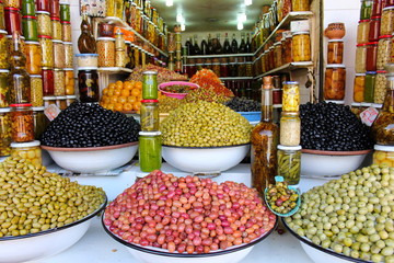 Colored pickled olives and vegetables on a market stall in the m
