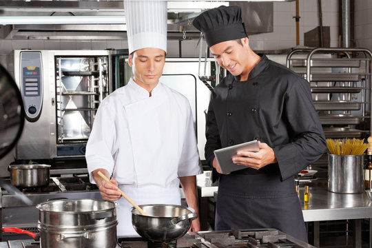 Chefs Preparing Food In Kitchen