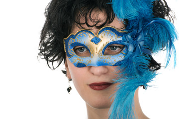 Woman with blue eyes wearing a feathered Venetian mask