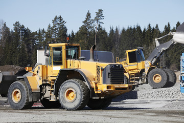 Fototapeta premium heavy duty trucks working inside gravel industry pit