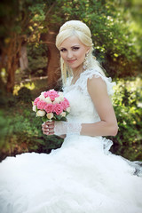 Beautiful bride with bouquet of flowers, Outdoors portrait
