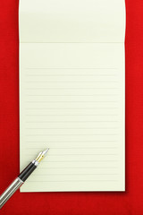 Blank notebook on red background