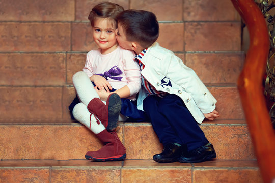little gentleman kisses girl