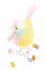 Funny easter hen with colored eggs on white