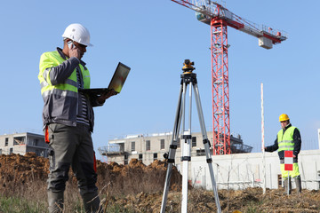 Two surveyors working on site