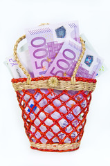 500 euro money banknotes in a small basket, isolated
