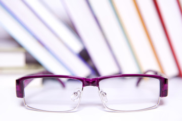 Glasses on book background