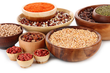 Different kinds of beans in bowls isolated on white