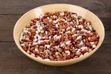 Beans in bowl on wooden background