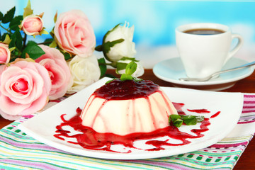 Panna Cotta with raspberry sauce, on bright background