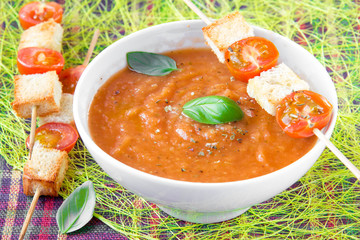 Delicious starter - red soup with tomato and basil