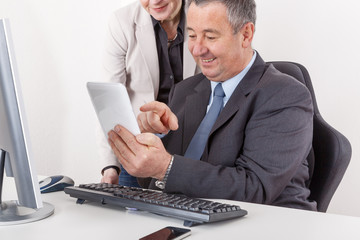 Businessman and businesswoman with tablet PC