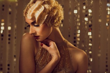 Elegant blond retro woman  in golden dress 