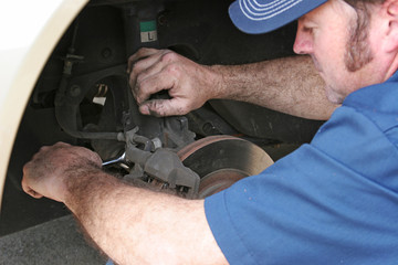 Auto Mechanic Works on Brakes
