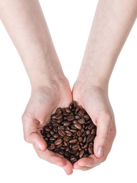 female teen hand holding coffee bean