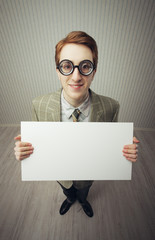 Business man nerd holds a blank sign