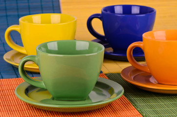 A set of colorful cups with plates