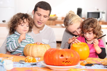 Family decorating pumpkins