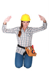 Tradeswoman holding up her hands
