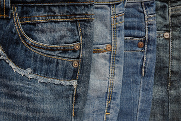 It is a close up of pile of jeans.