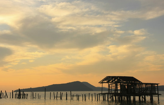 Silhouette of old wooden jetty at sunrise, Koh Rong island, Camb