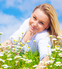 Attractive girl on daisy glade