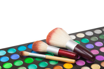makeup brushes and set of colorful eye shadows
