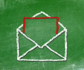 E-mail symbol drawn with chalk on blackboard 