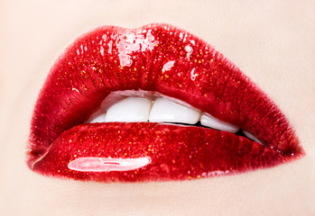 Beautiful female with red shiny lips closeup