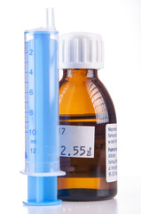 Syringe and sirup isolated on white