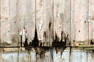 rotting wooden panels crumbling with decay