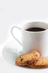 A cup of coffee with some cookies on white background