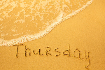 Thursday - written in sand on beach texture