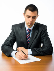 businessman writing on a form