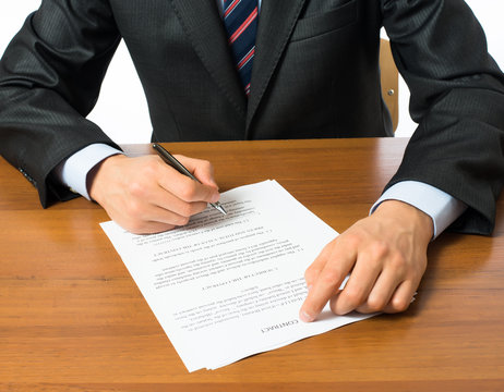 businessman writing on a form
