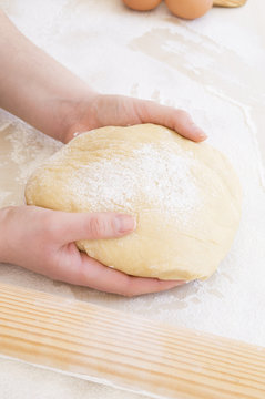 taking the dough with both hands