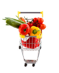 Shopping trolley full of vegetables on white background