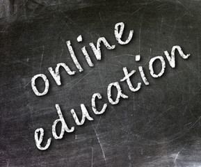 Fototapeta premium Online education school written on a chalkboard