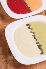 Different colored puree soups