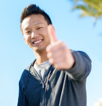 Happy Asian Man Showing Thumb Up Sign