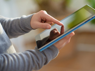 Close-up Of Hand Holding Digital Tablet