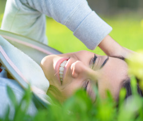 Young Woman Lying On Grass