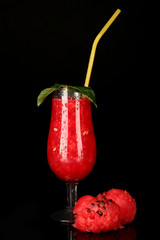 A glass of fresh watermelon juice isolated on black
