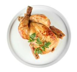 Roasted whole chicken on a white plate isolated on white